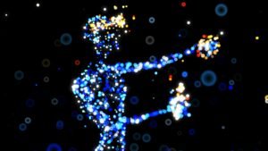 Silhouette humaine composée de particules lumineuses bleues et multicolores sur fond noir.